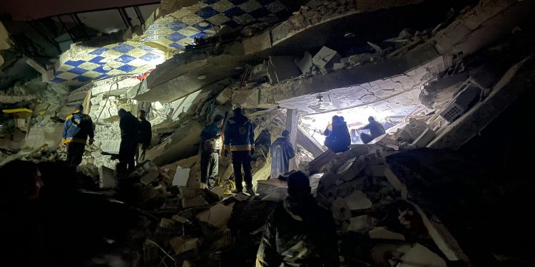 Syrian rescuers (White Helmets) and civilians search for victims and survivors amid the rubble of a collapsed building following an earthquake, in the rebel-held northern countryside of Syria's Idlib province on the border with Turkey, early on February 6, 2023, - At least 50 have been reportedly killed in north Syria after a 7.8-magnitude earthquake that originated in Turkey and was felt across neighbouring countries. (Photo by Aaref WATAD / AFP) (Photo by AAREF WATAD/AFP via Getty Images)

Rescue workers search the rubble of a collapsed building in Idlib, Syria, on February 6. (Aaron Watad/AFP/Getty Images)