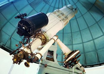 modern large telescope in observatory with windows closed